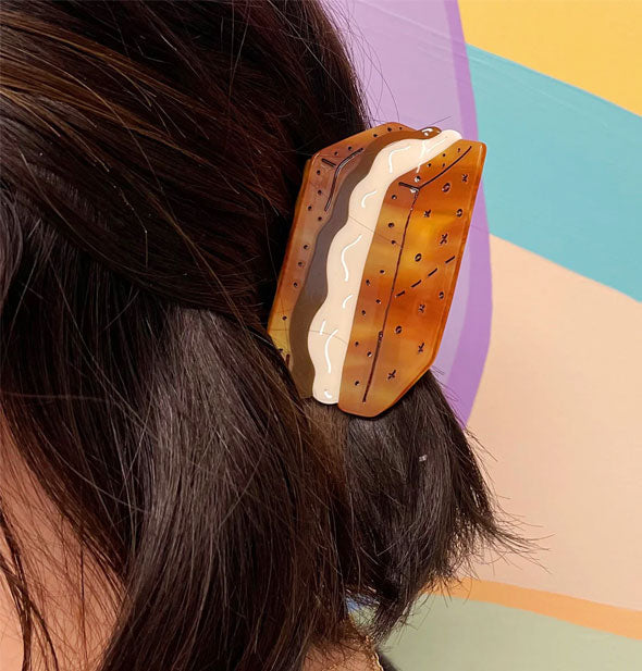 Model wears a hair clip designed to resemble a s'more