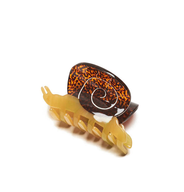 Snail hair clip with amber-colored body and brown speckled shell top with white swirl