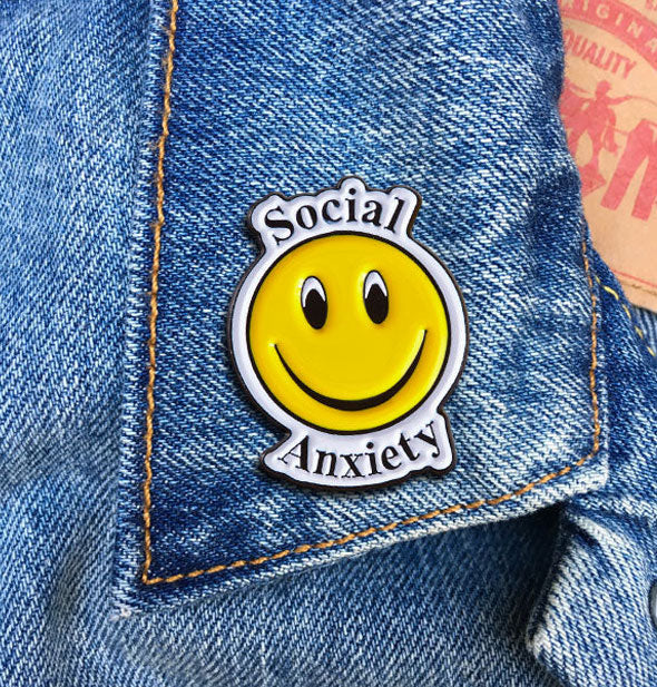 Social Anxiety smiley face enamel pin on jean jacket lapel