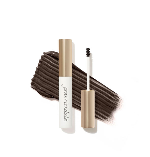 White and gold Jane Iredale brow gel tube with spoolie applicator shown features a product sample application behind in Soft Black