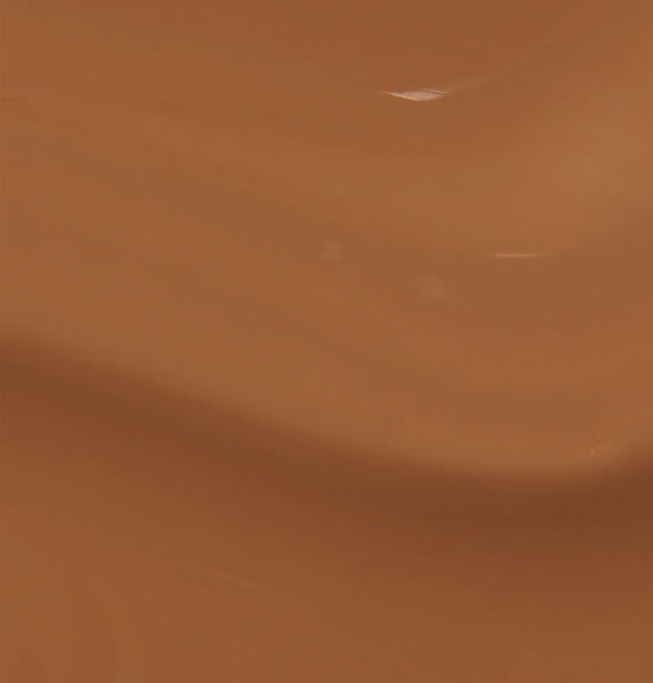 Closeup of warm, caramel-brown nail polish