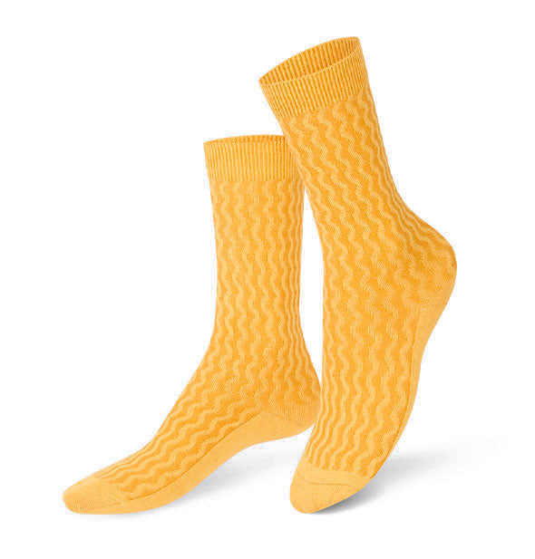 Pair of yellow crew socks with wavy "noodle" pattern