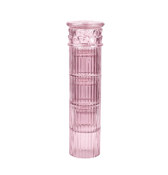 Tower of four pink drinking glasses with stackable design resemble a Greek column