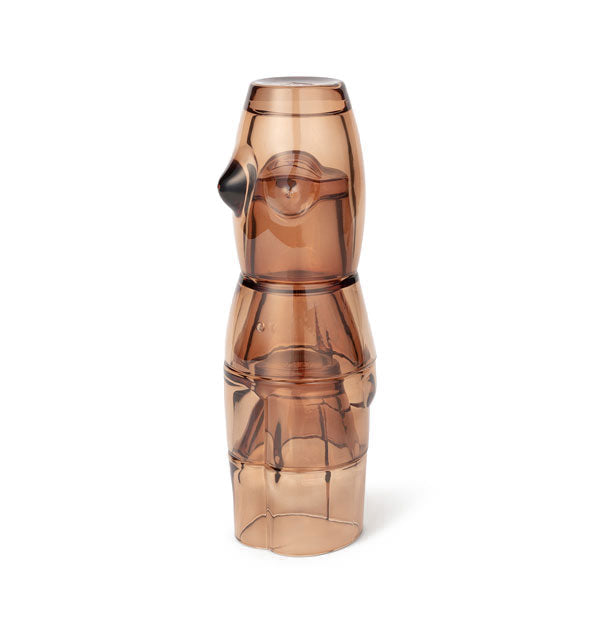 Four stacked brown glass cups form the shape of a woman's body