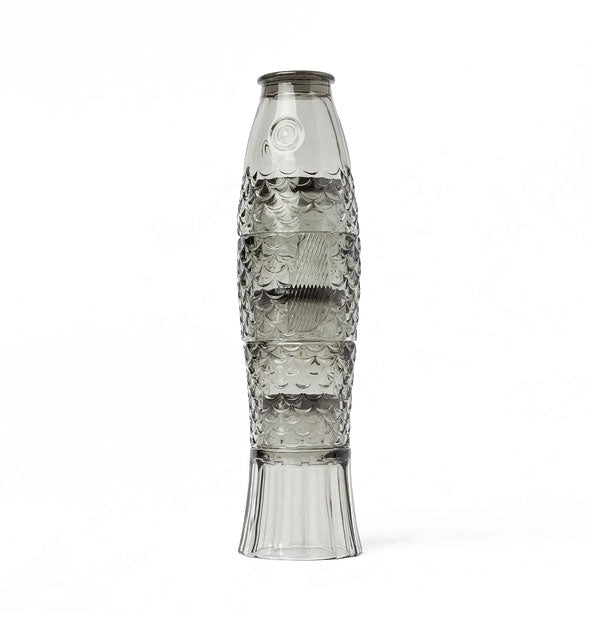 Four gray drinking glasses stacked one on top of the other form a koi fish with scales