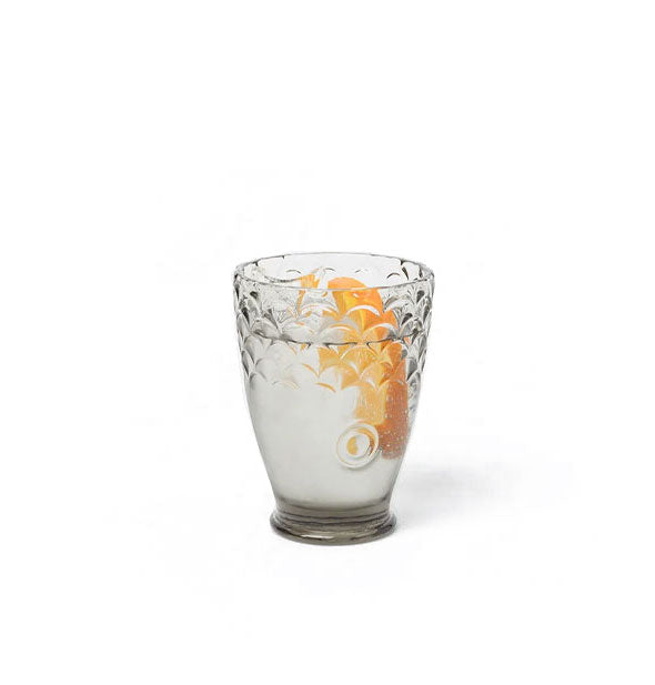 Gray koi fish head drinking glass with scaly texture and orange garnish inside