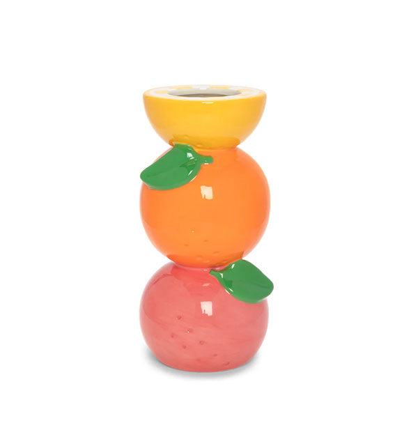 Vase designed and painted to resemble a pink grapefruit, orange, and half yellow lemon stacked on top of each other with two green leaf accents