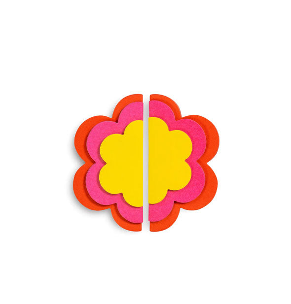 Six stacked sticky note pads form halves of a "mod" flower in red, pink, and yellow
