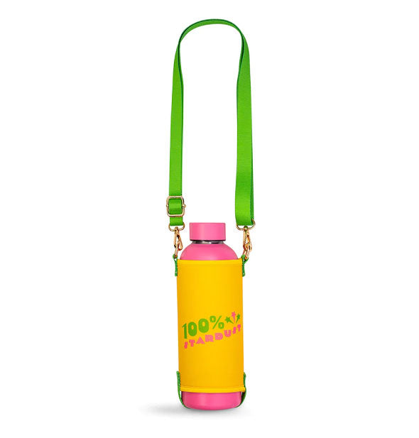 Pink water bottle with yellow sleeve that says, "100% Stardust" in yellow and green lettering has a green carrying strap attached with gold hardware