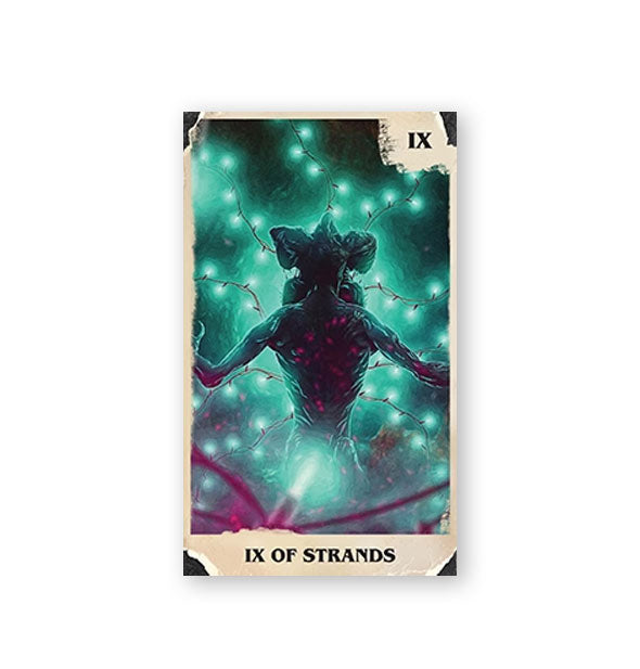 IX of Strands card from the Stranger Things Tarot Deck features greenish illustration of the Demogorgon surrounded by red string lights