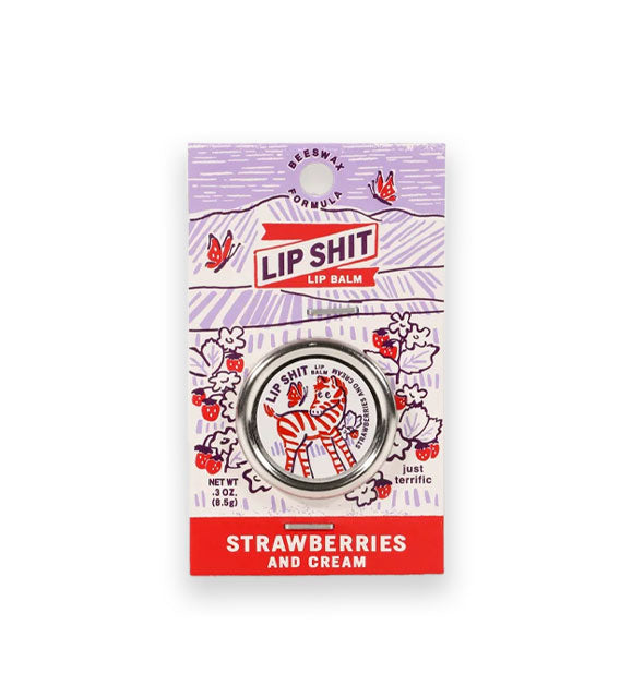 Pot of Strawberries and Cream Lip Shit Lip Balm on product card features monochromatic zebra cartoon and a pastoral scene of rolling hills, flowers, and butterflies