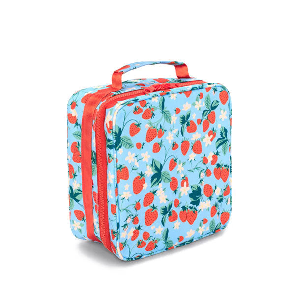 Square blue lunch bag with top handle and red zipper features all-over strawberry vine design in red, green, and white