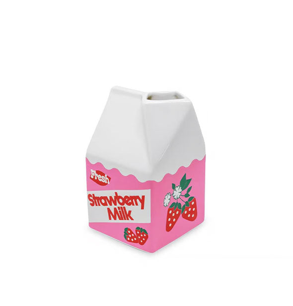 Ceramic vase designed to resemble a carton of strawberry milk with spout opening and pink label accented with strawberry graphics