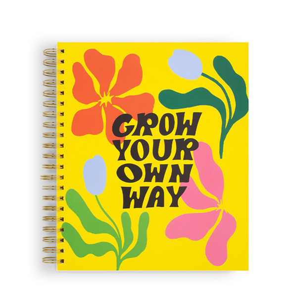 Wire-bound yellow notebook cover says, "Grow Your Own Way" in black lettering over a colorful amorphous floral design