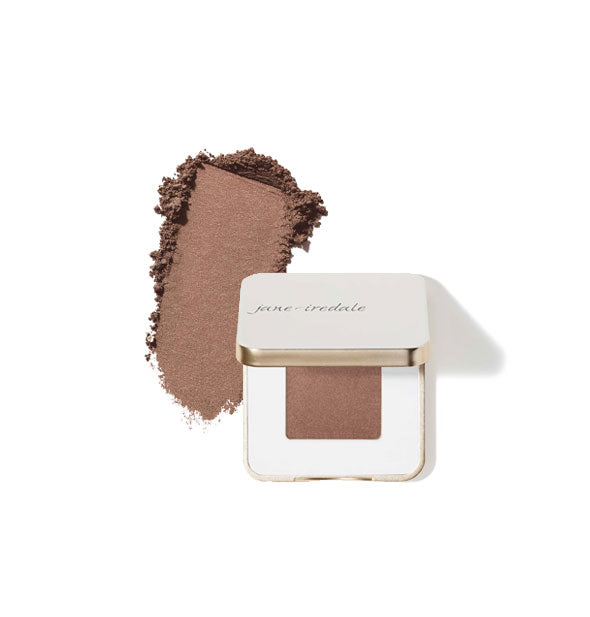 Opened square white and gold Jane Iredale eye shadow compact with sample product application at left in the shade Supernova