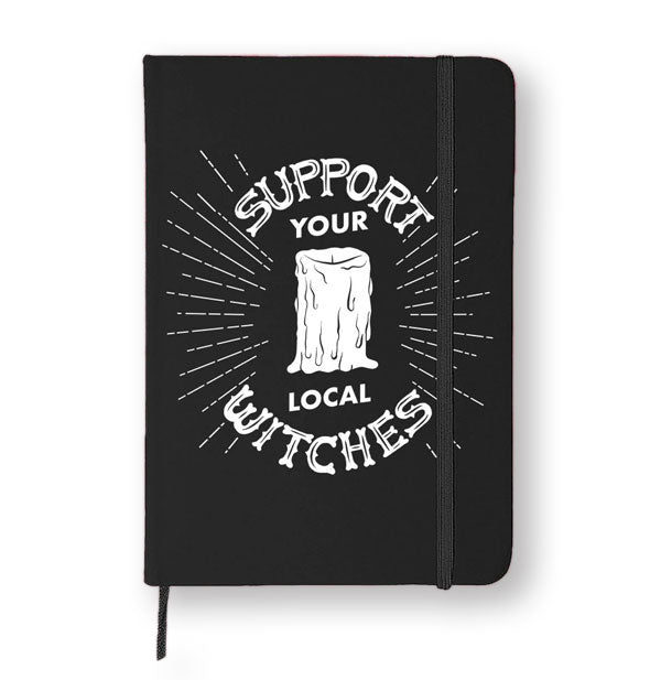 Black journal says, "Support Your Local Witches" in white lettering with candle graphic and radiating lines