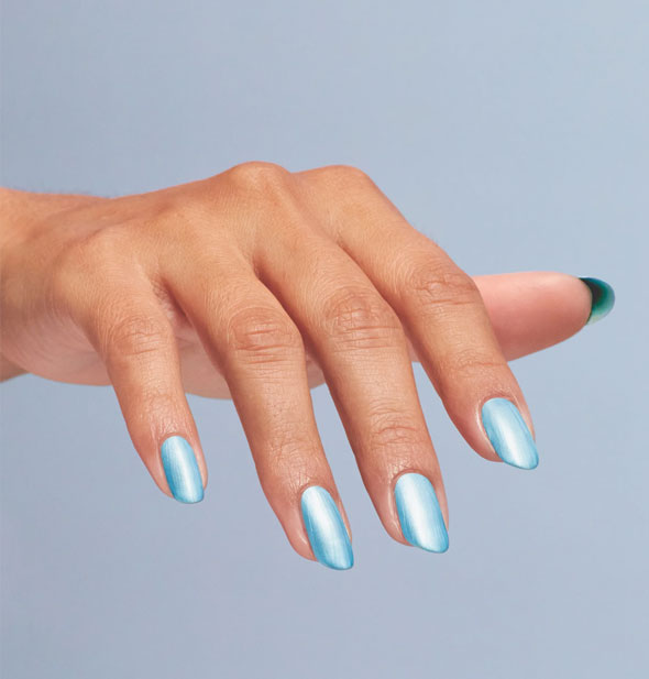 Model's fingernails are painted with shimmery blue nail polish