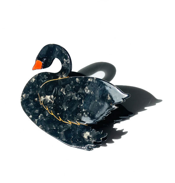 Quartz-effect black swan hair clip with gold edging and an orange beak