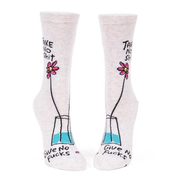 White crew socks with cartoon flower illustration say, "Take no shit" at the top and, "Give no fucks" on the toes