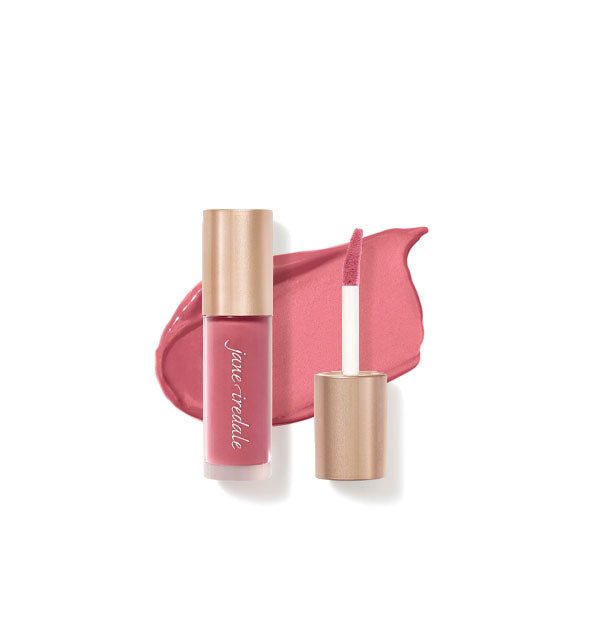 Tube of Jane Iredale Beyond Matte Lip Stain with separate gold doe foot applicator cap rest atop an enlarged sample application of product in shade Temptation