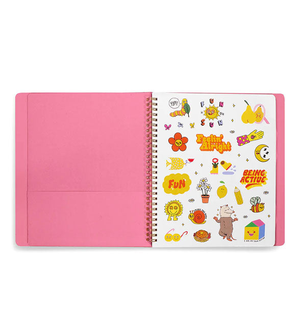 Open planner reveals a pink cover interior with spiral-bound pocket page and sticker sheet