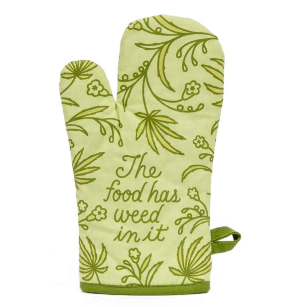 Two-tone green oven mitt with design of flowers and leaves says, "The food has weed in it" in script near the bottom