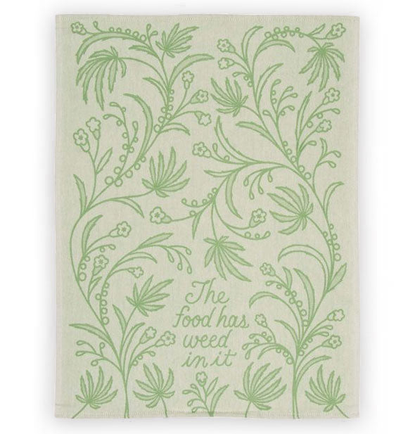 Beige dish towel with green botanical designs says, "The food has weed in it" in green script in the center