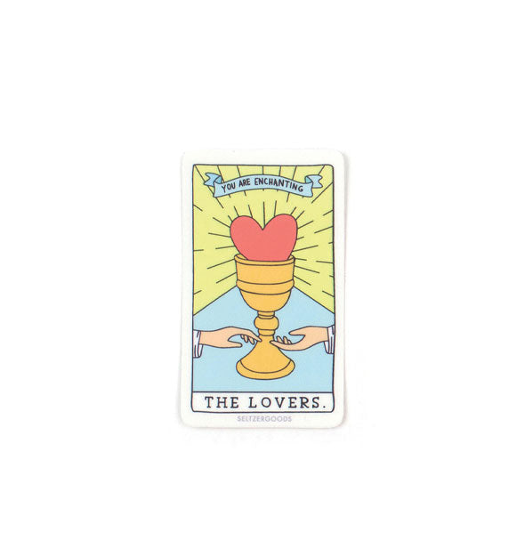 Rectangular sticker features artwork in the style of The Lovers tarot card with a chalice, heart, two hands, and banner at the top that says, "You are enchanting"