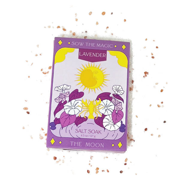 Purple packet of Lavender Salt Soak surrounded by salt granules features celestial and floral "The Moon" tarot-\themed artwork