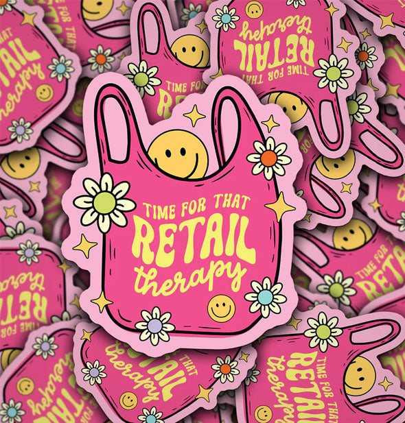 Pile of pink stickers illustrated with a shopping bag design accented by flowers, stars, and smiley faces which says, "Time for that retail therapy" in yellow lettering