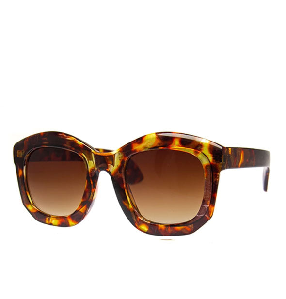 Pair of rounded sunglasses in a brown tortoise finish and amber gradient lenses