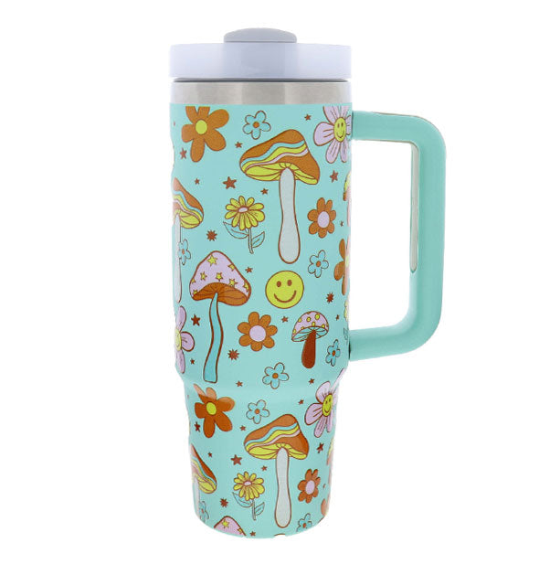 Bright aqua drink tumbler with squared handle and lid features all-over colorful print of mushrooms, smiley faces, and flowers