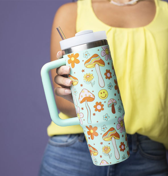 Model holds a Totally Happy Tumbler out toward camera