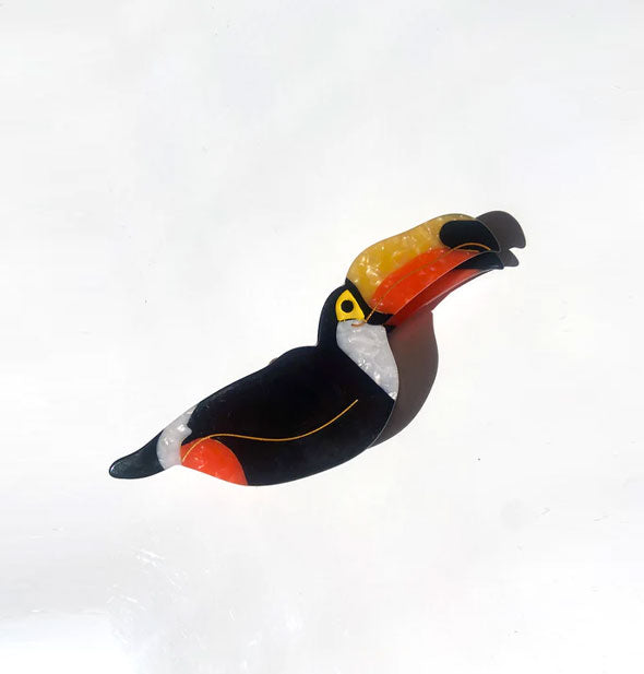 Black, white, yellow, and orange toucan claw clip with gold line details
