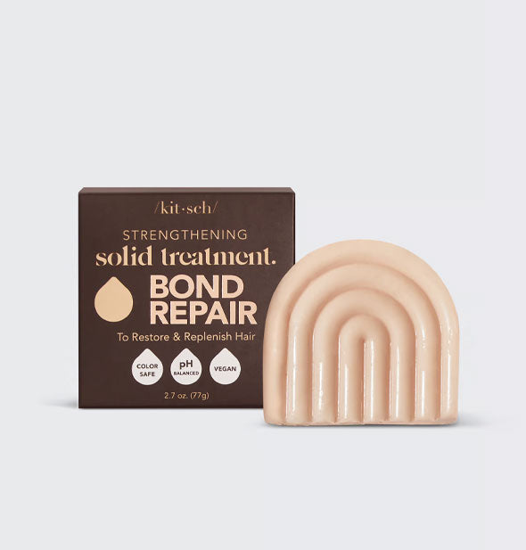 Light-colored, rainbow-shaped Bond Repair hair treatment bar by Kitsch with brown box packaging