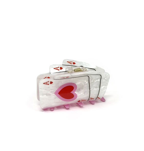 Hiar clip designed to resemble three ace of hearts playing cards with a white pearlescent finish and red and pink details
