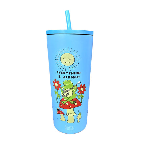 Blue drink tumbler with lid and straw features an illustration of a green frog sitting on top of a mushroom strumming a banjo surrounded by other mushrooms and flowers underneath a smiling sun and the words, "Everything is alright"
