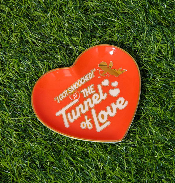 Red heart Tunnel of Love dish rests on green astroturf