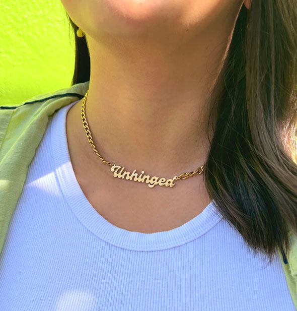 Model wears a gold Unhinged nameplate curb chain necklace