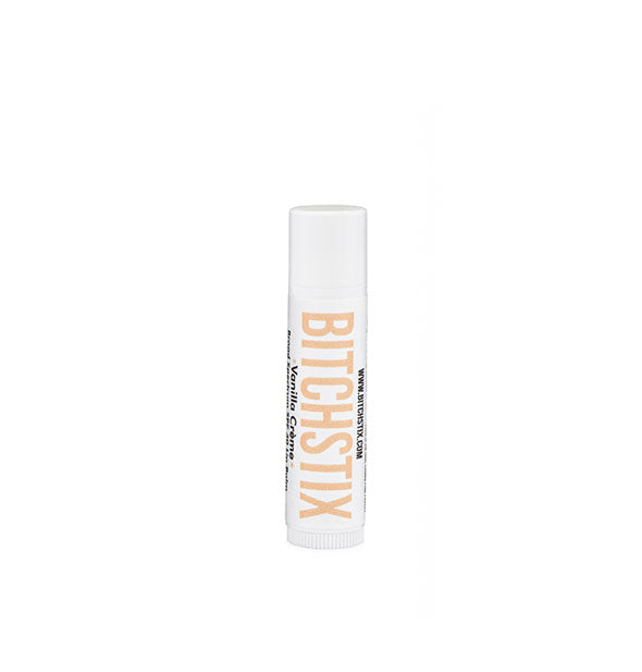 White tube of Bitchstix lip balm with light peach lettering