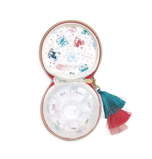 Pill case interior features a labeled 7-day plastic divider and zodiac sign print lining