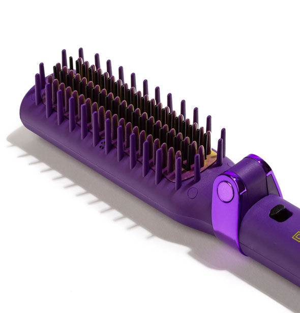 Angled view of the bristled head of a Glister Foldable Smoothing System brush iron in violet