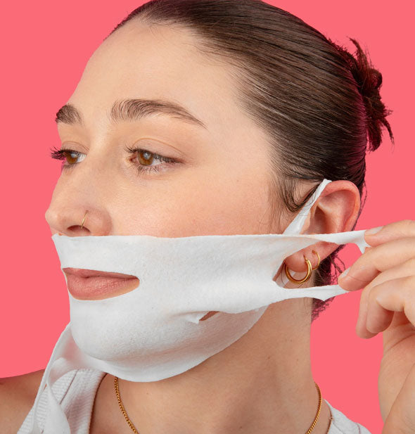 Model demonstrates placement of the Lapcos V-Line Contour Face Sheet Mask