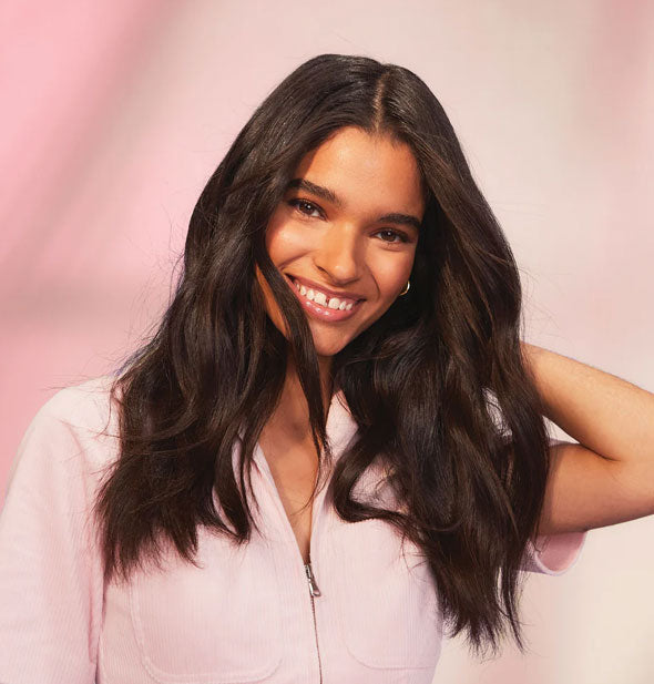 Smiling model has full-looking, long hair