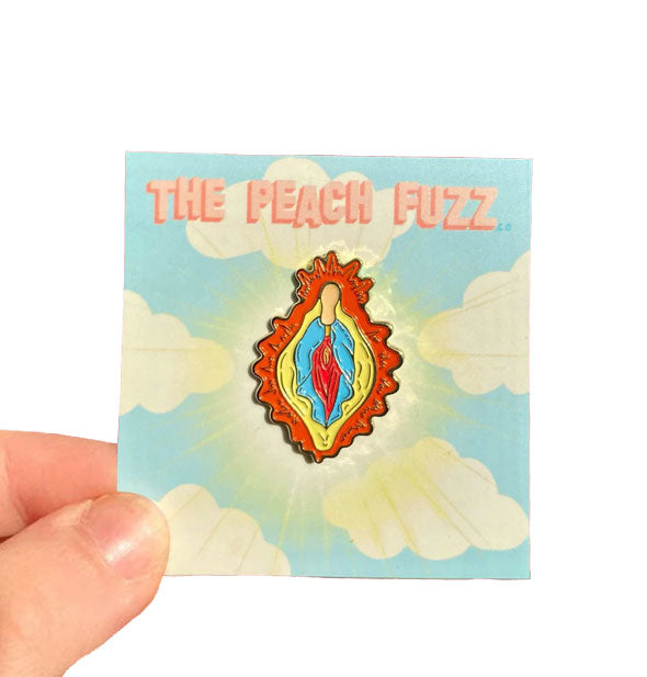 Colorful "Vulva Mary" enamel pin by The Peach Fuzz on cloud card with radiant aura design