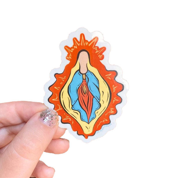 Model's hand holds a sticker with colorful, stylized design of vulvar anatomy