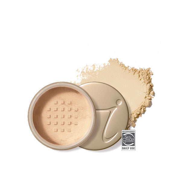 Opened round Jane Iredale loose powder compact with stamped gold lid and product application behind it in shade Warm Silk