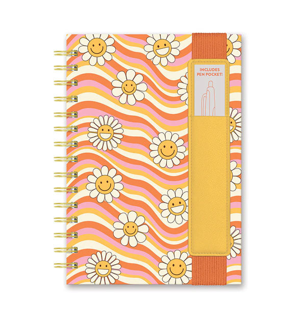 Spiral-bound notebook with wavy white, yellow, purple, and coral stripes dotted with smiley face daisies features a yellow and coral pen pocket sleeve
