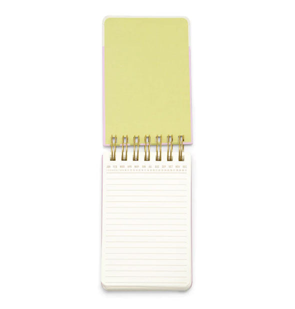 Opened notepad with pastel lime cover interior and lined page with "perpetual" heading of months and days of the year
