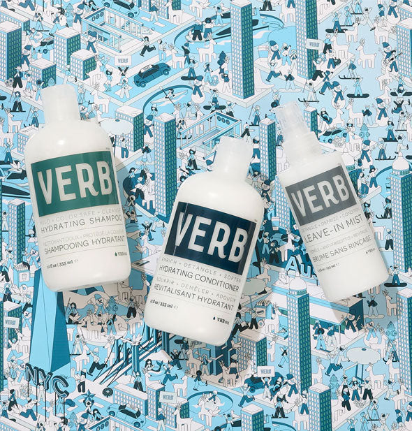 Bottles of Verb Hydrating Shampoo, Hydrating Conditioner, and Leave-In Mist on a blue illustrated NYC cityscape patterned surface